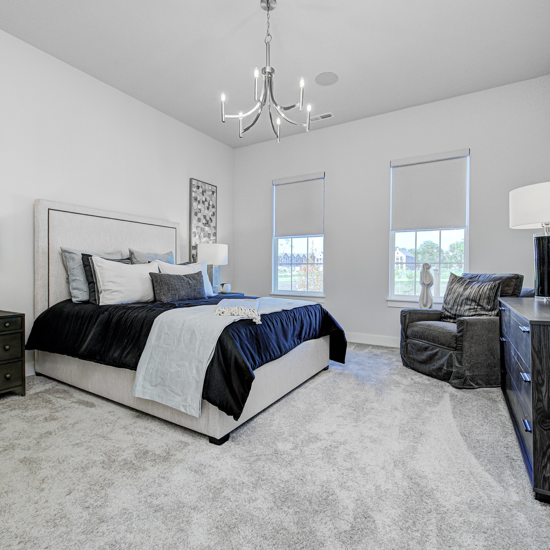 A bedroom with a bed and a dresser.