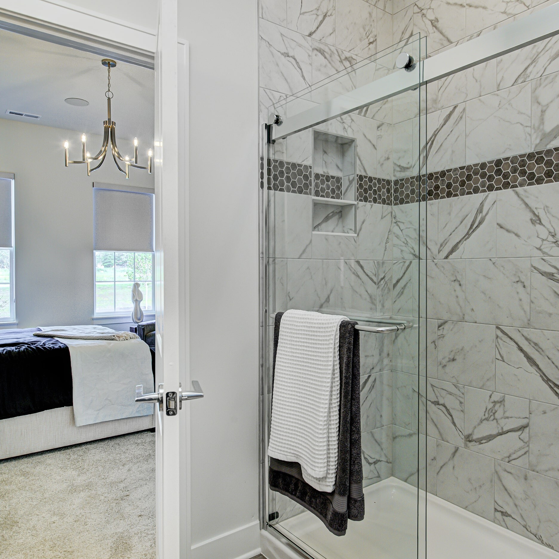 A bathroom with a glass shower door.