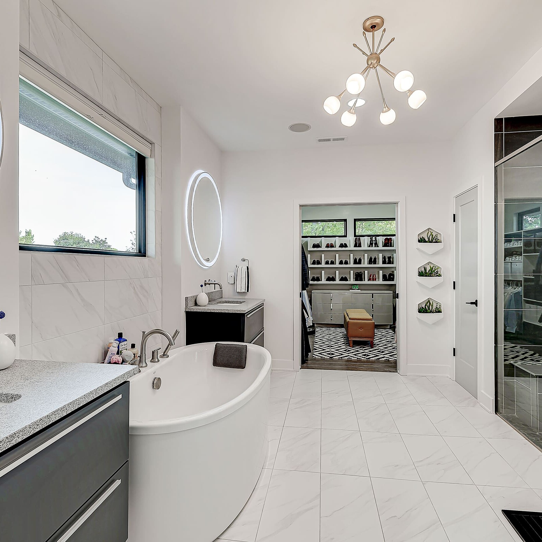 A modern bathroom with a large tub and sink.