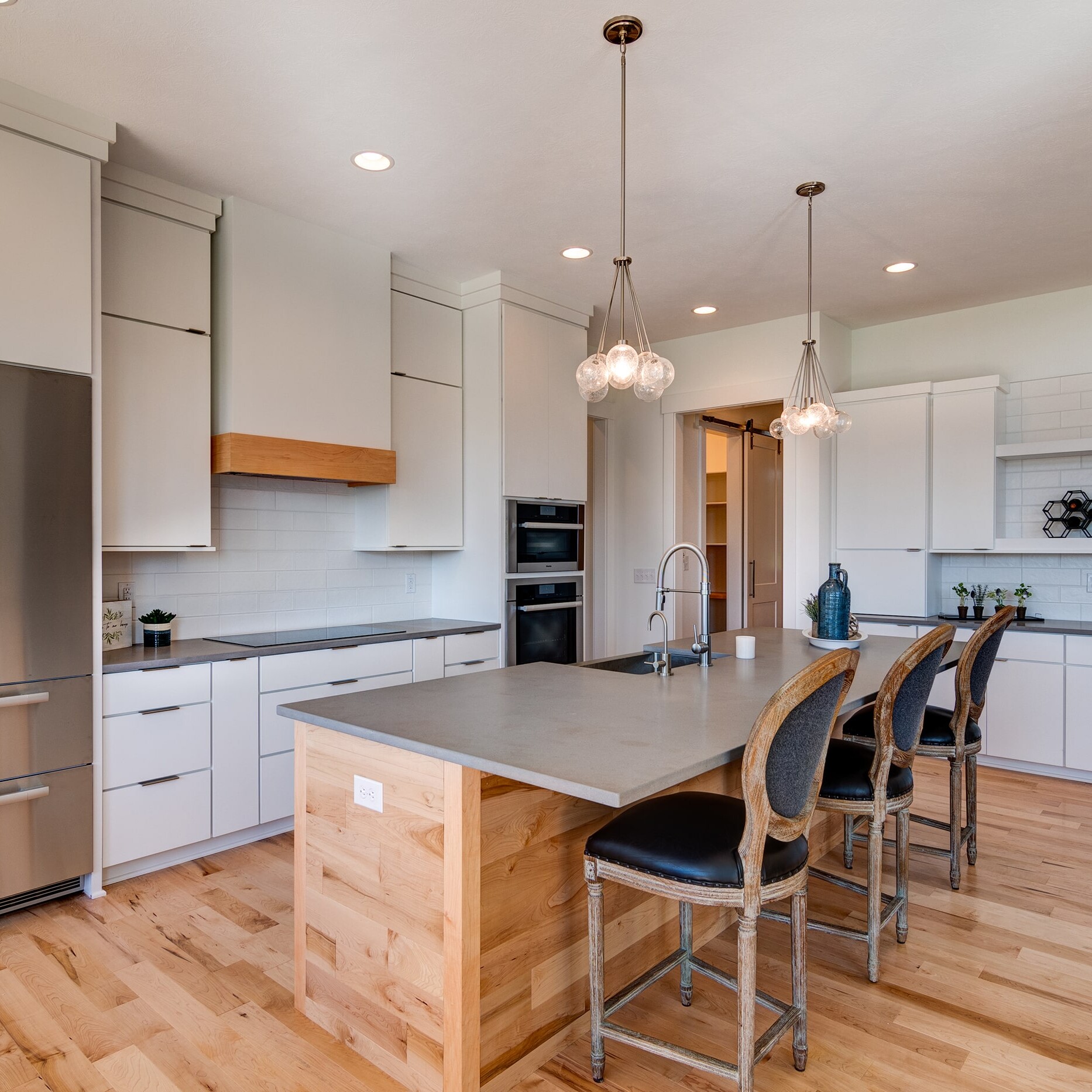 A kitchen with white cabinets and stainless steel appliances.