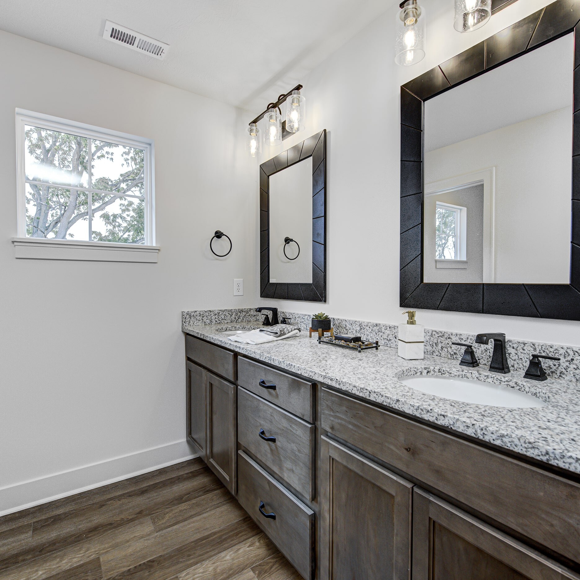 A bathroom with two sinks and mirrors.