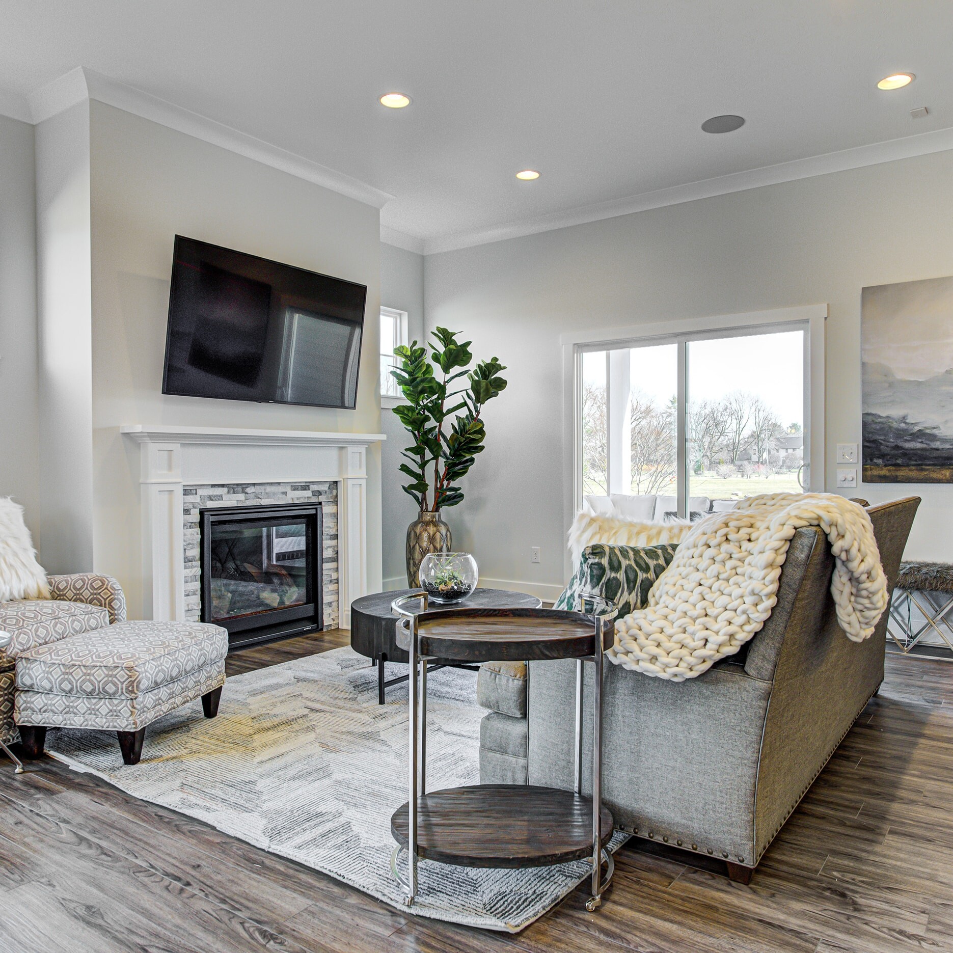 A living room with hardwood floors and a fireplace.