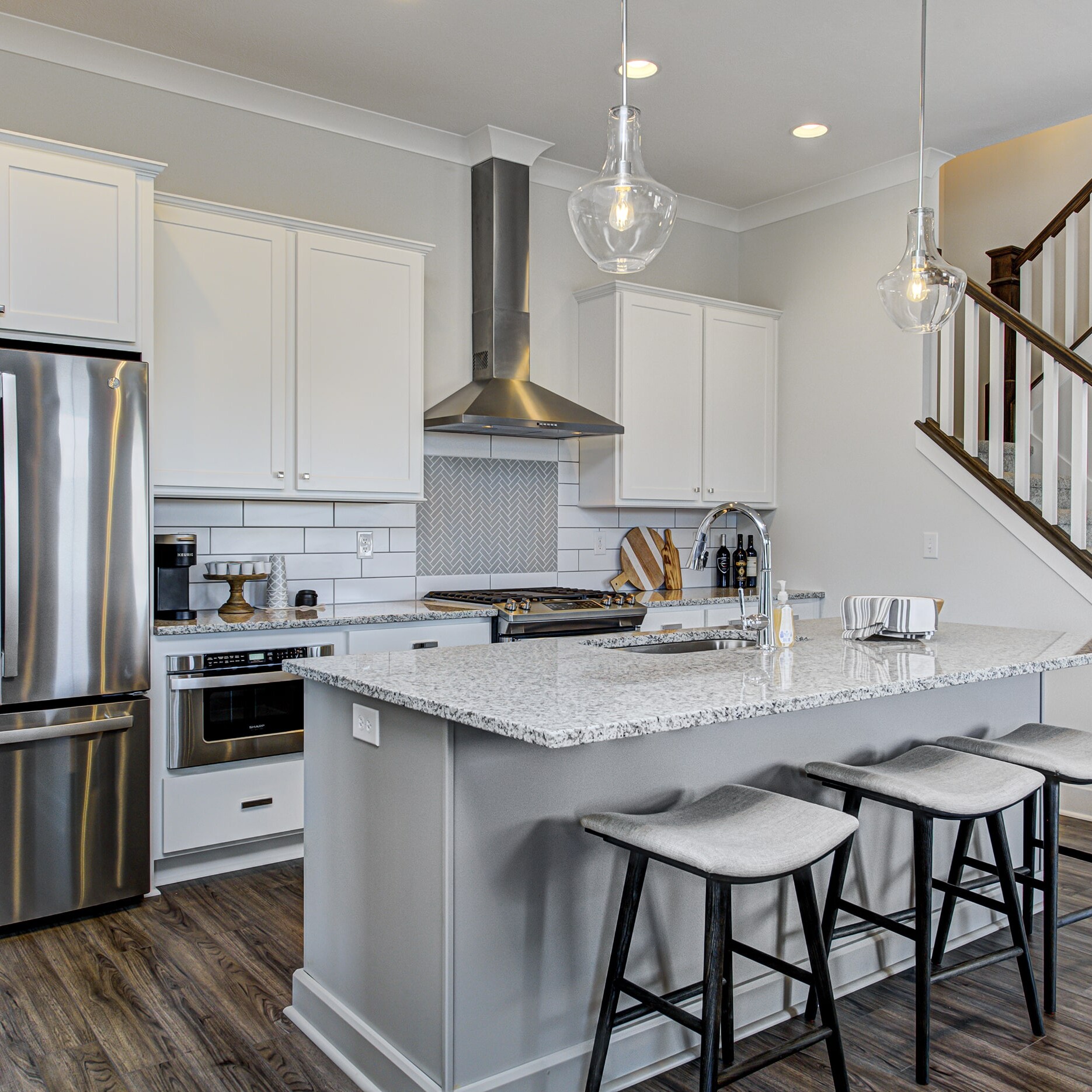 A kitchen with white cabinets and stainless steel appliances.
