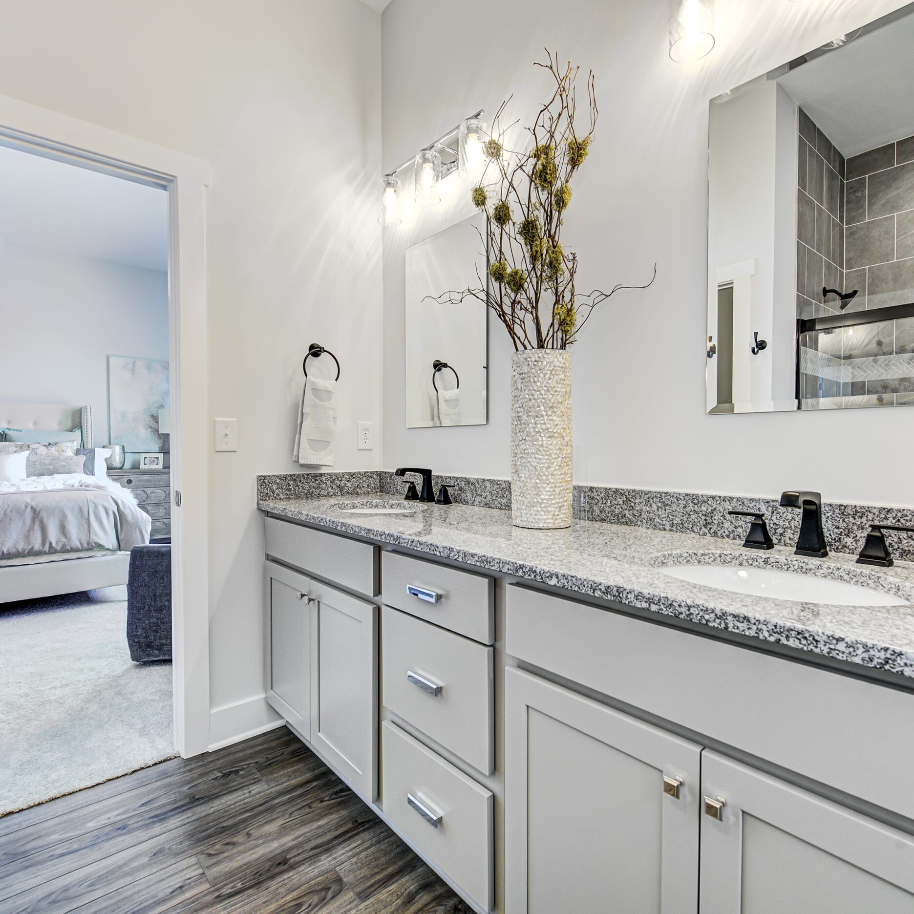 A bathroom with two sinks and a large mirror.