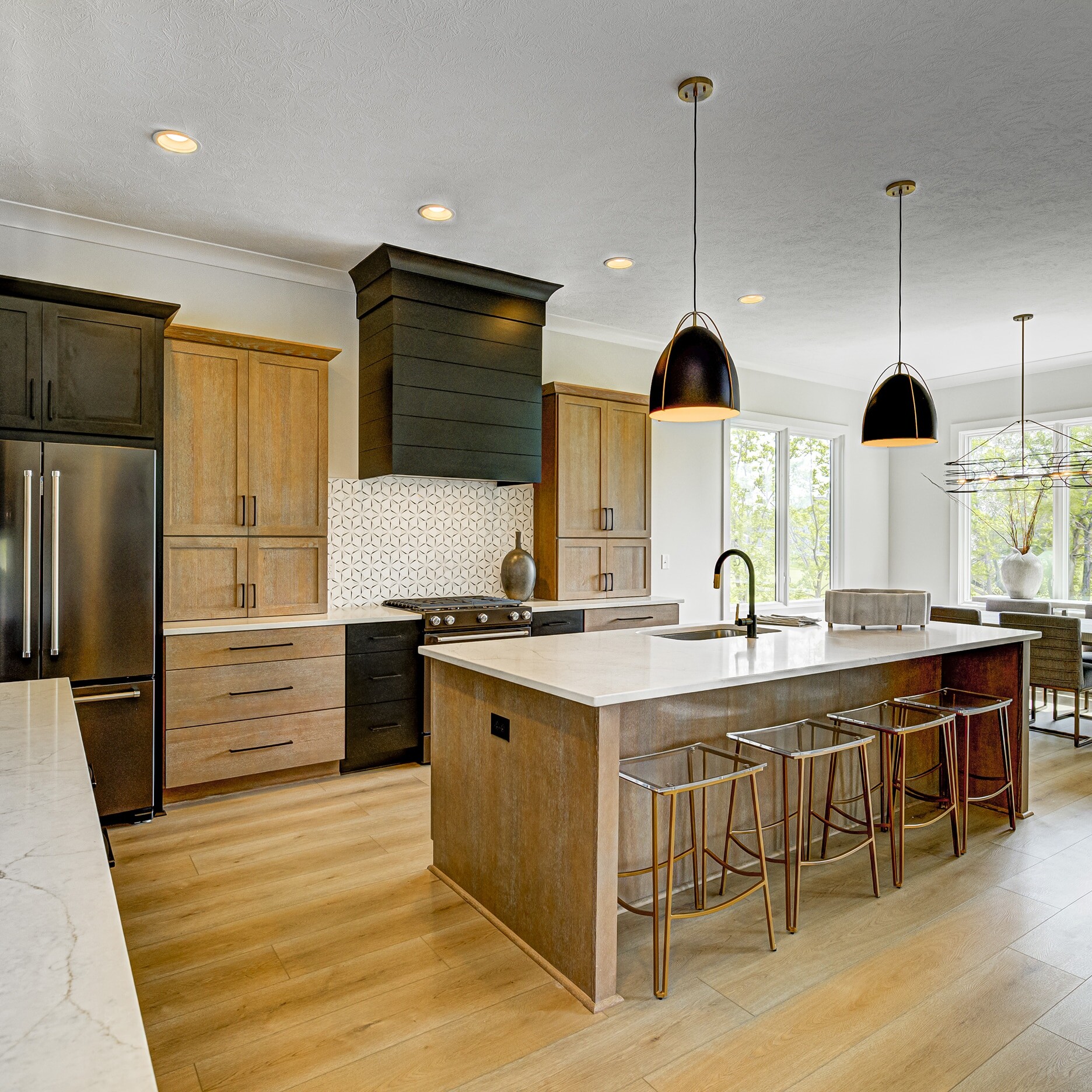 A kitchen with a center island and bar stools.