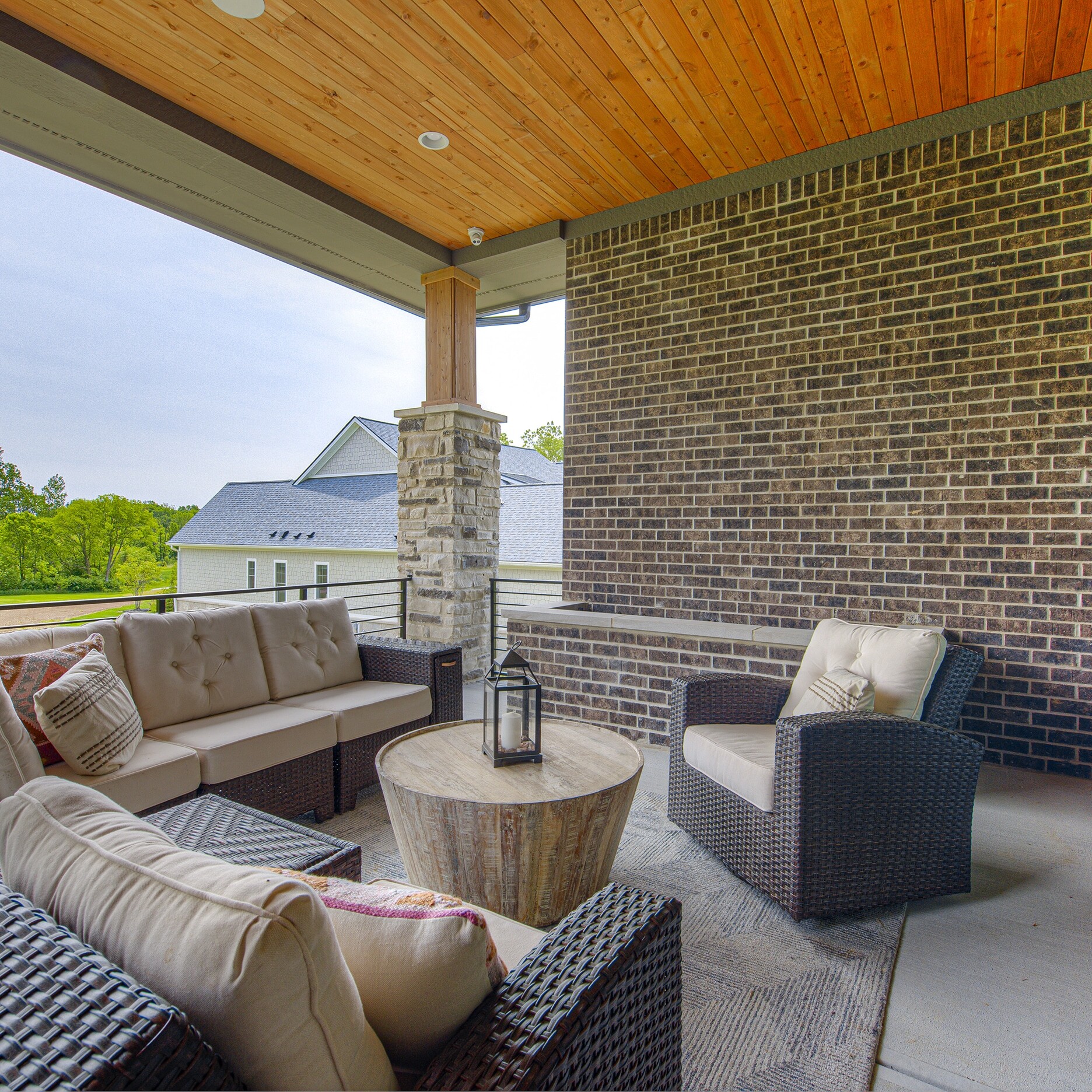A patio with wicker furniture and a table.