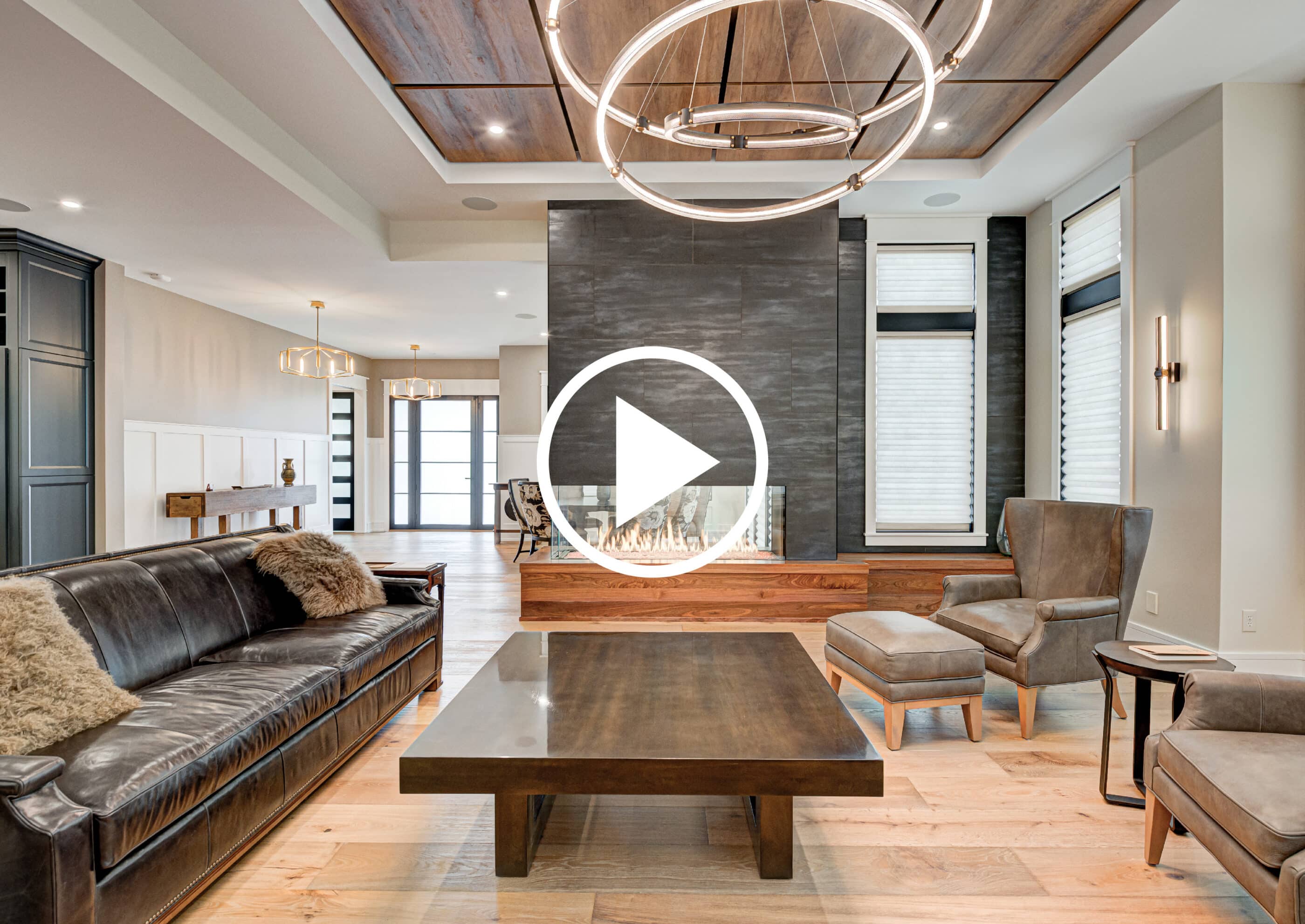 A living room with leather furniture and a fireplace in an Indianapolis custom home.