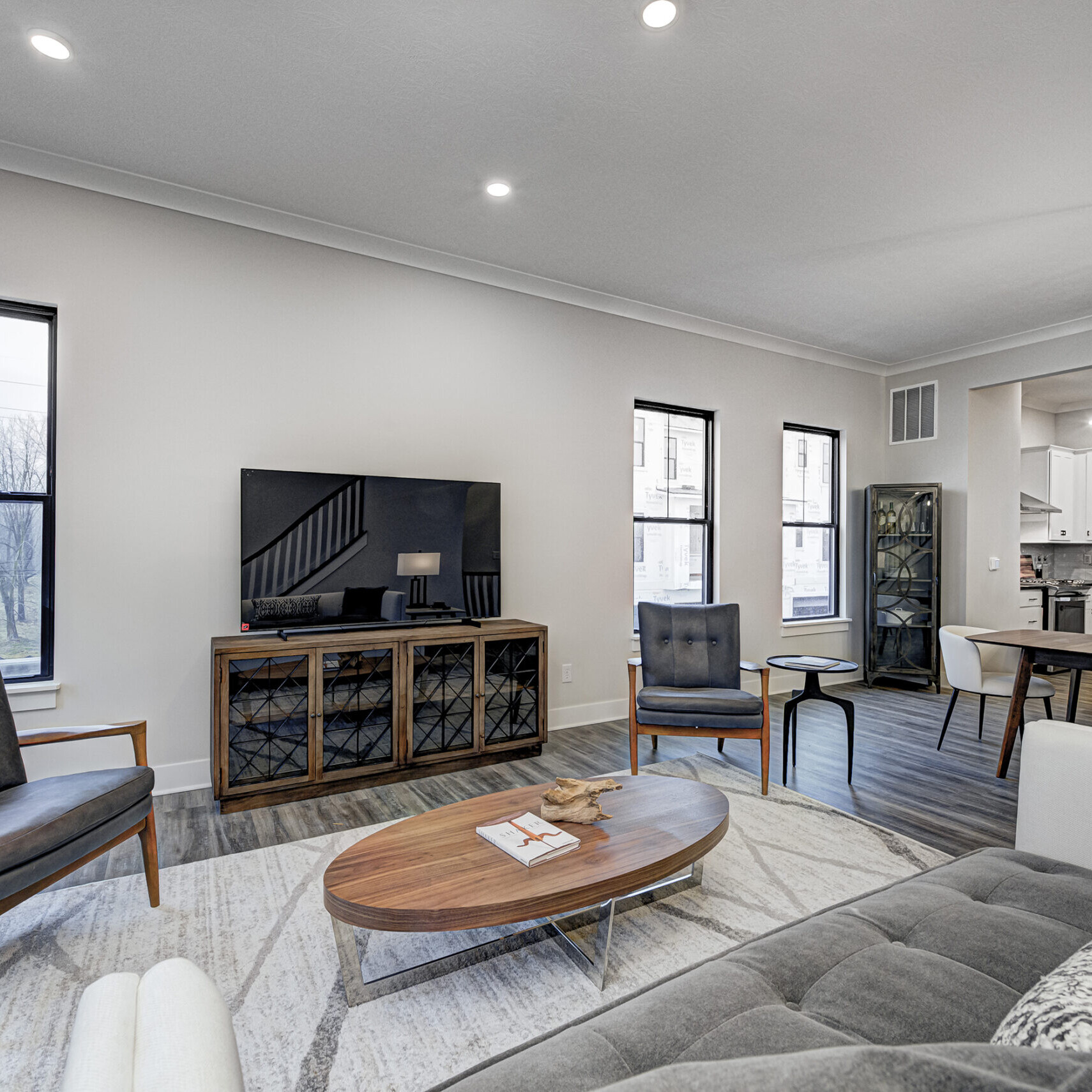 A living room with couches and a TV, designed by a Custom Home Builder Carmel Indiana.