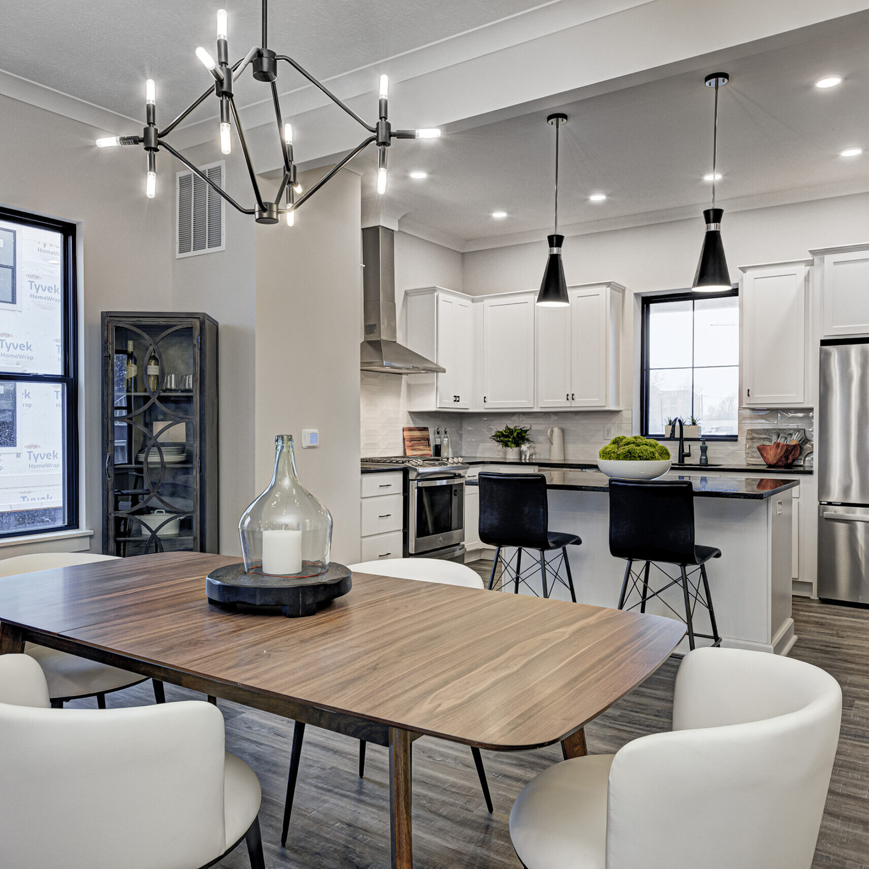 A contemporary kitchen with a dining table and chairs.