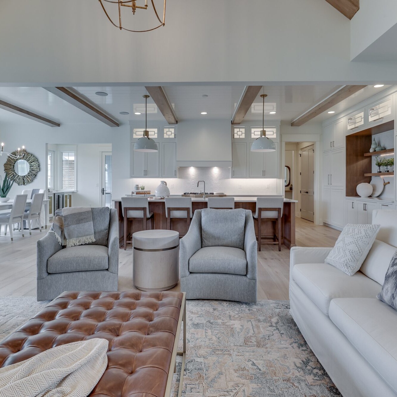 A white living room with a vaulted ceiling.