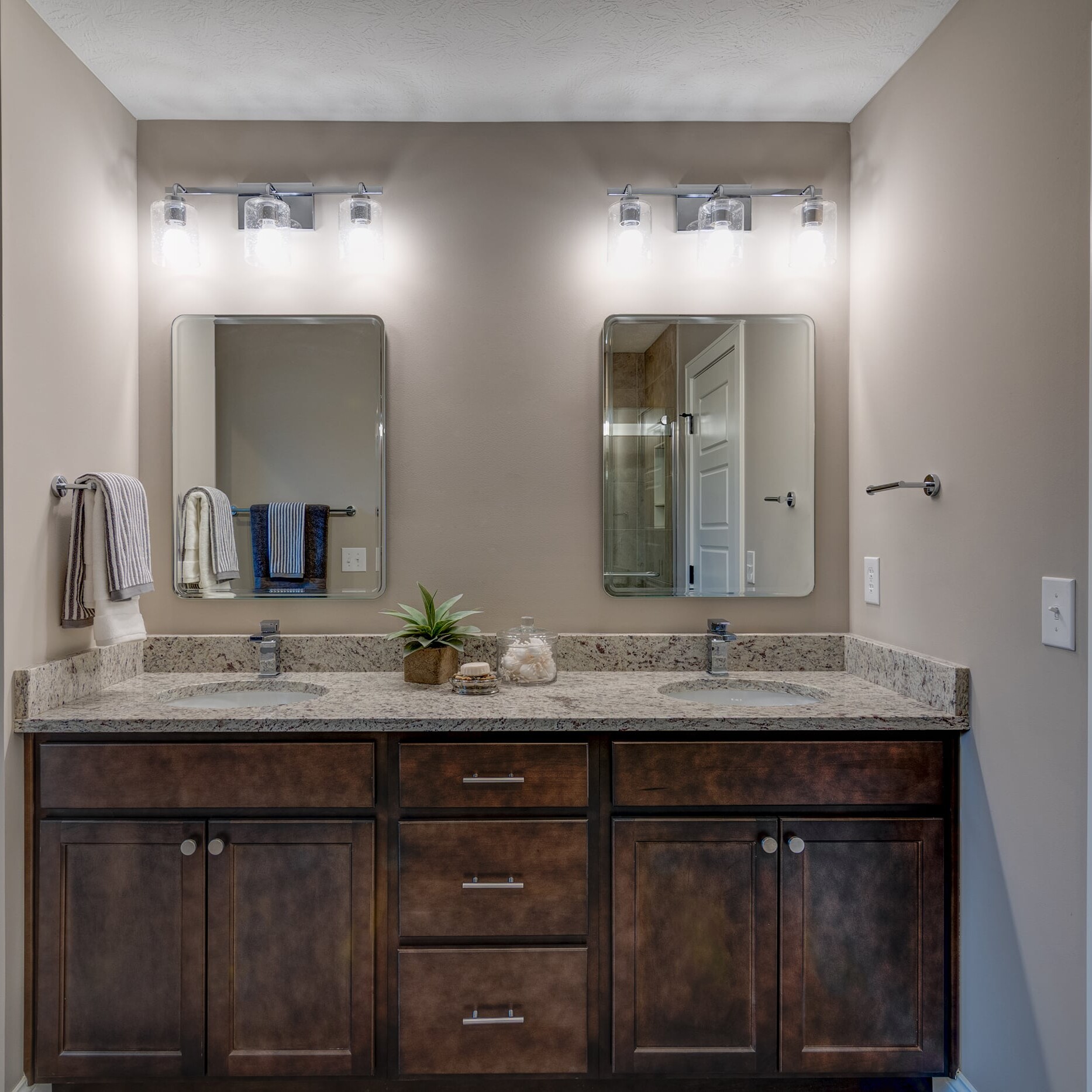 A bathroom with two sinks and a mirror.
