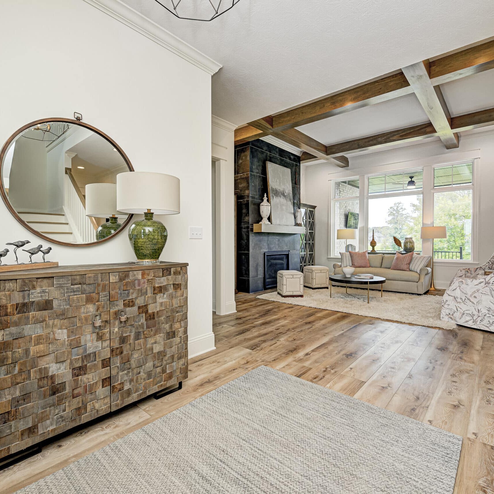 A custom living room with hardwood floors and a mirror.