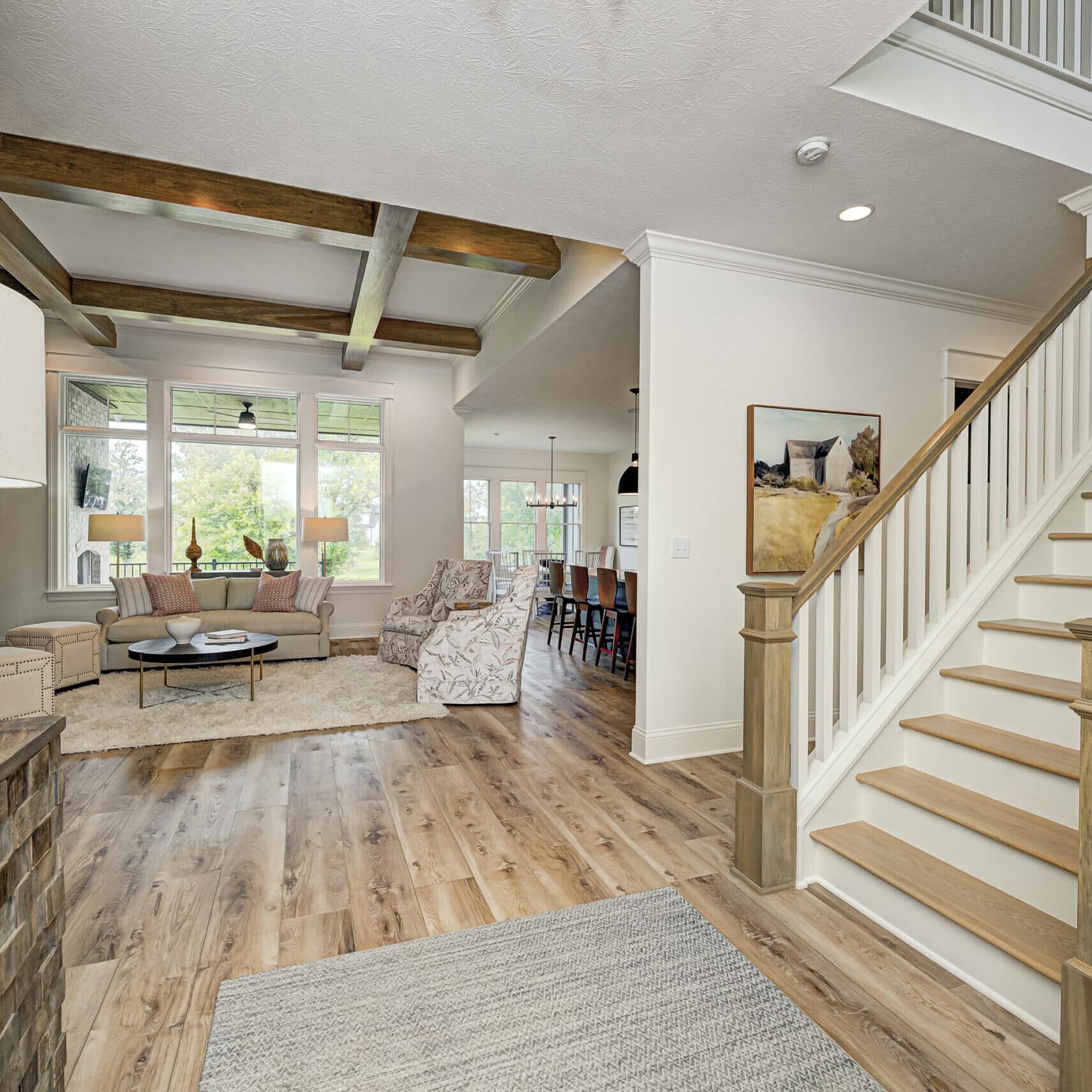 A magnificent living room with exquisite hardwood floors and a elegant staircase, meticulously crafted by our Custom Home Builder in Carmel Indiana. This is the epitome of luxury living in Indianapolis with our stunning