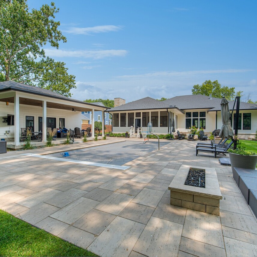 A backyard with a fire pit and patio furniture.