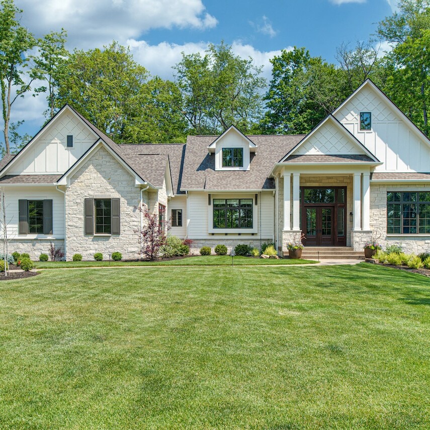 A home with a large lawn and trees.
