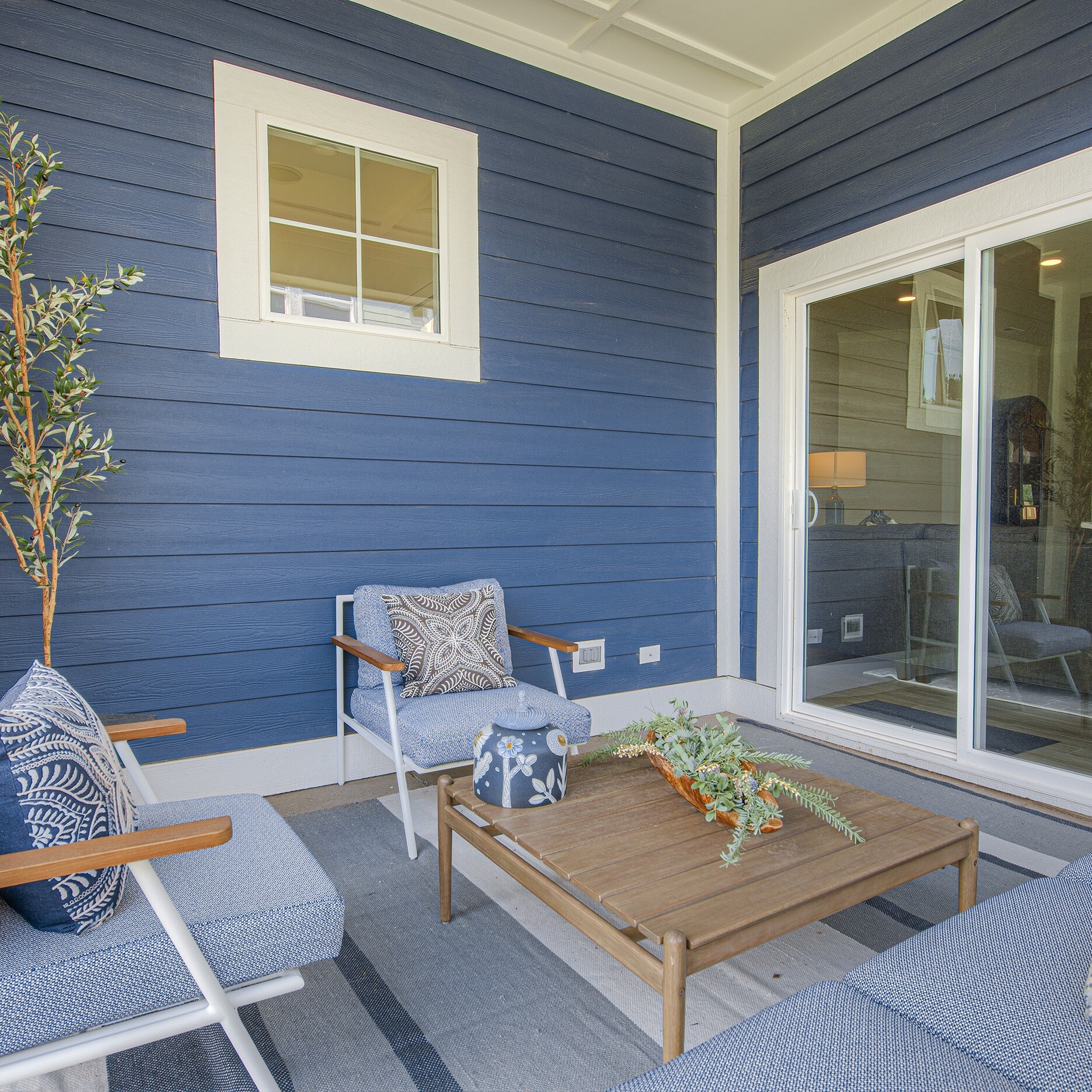 A blue and white patio with a table and chairs.