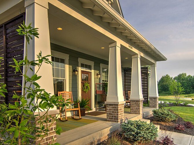 A cozy front porch of a home with a rocking chair, perfect for relaxation and enjoying the pleasant surroundings.