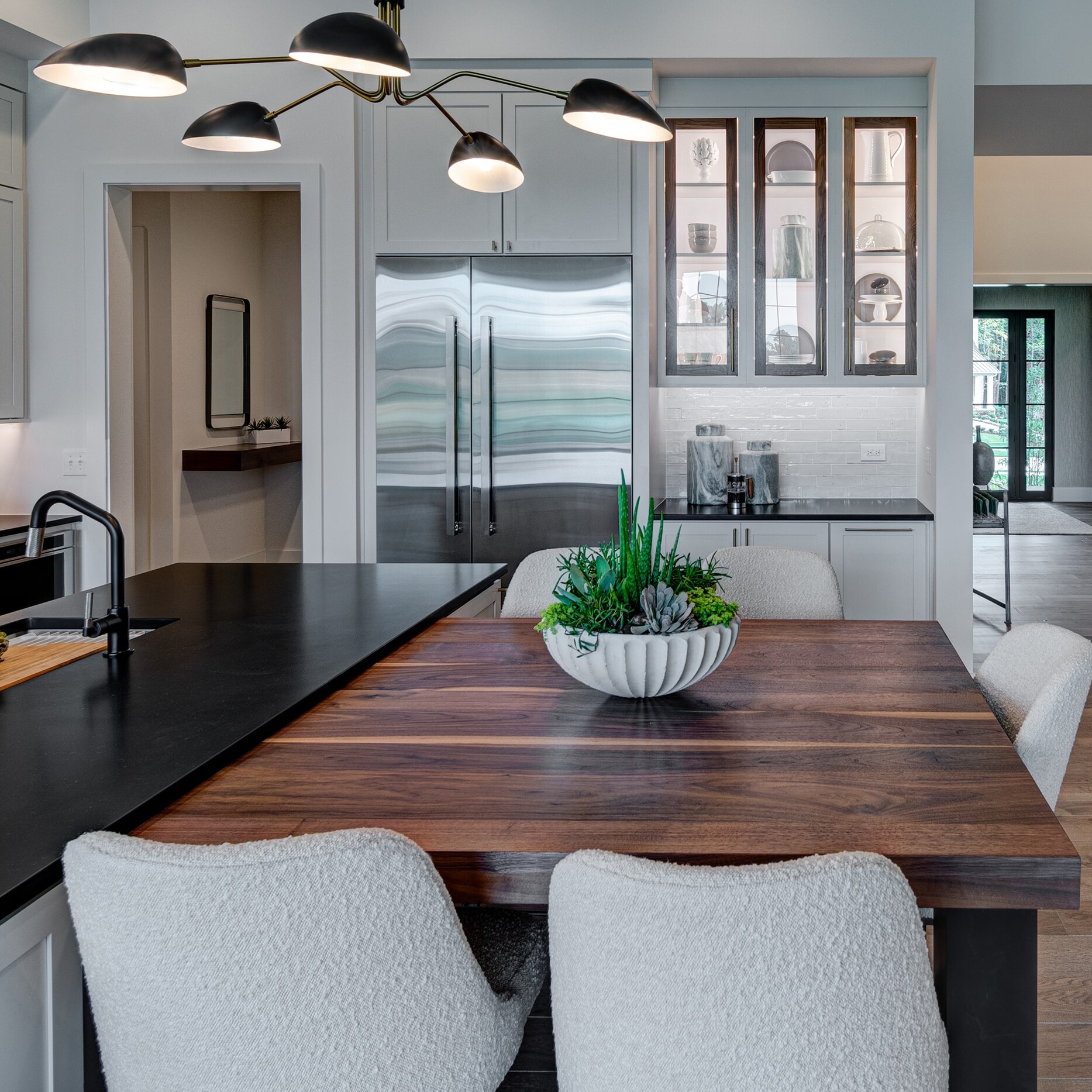 A kitchen with a table and chairs.