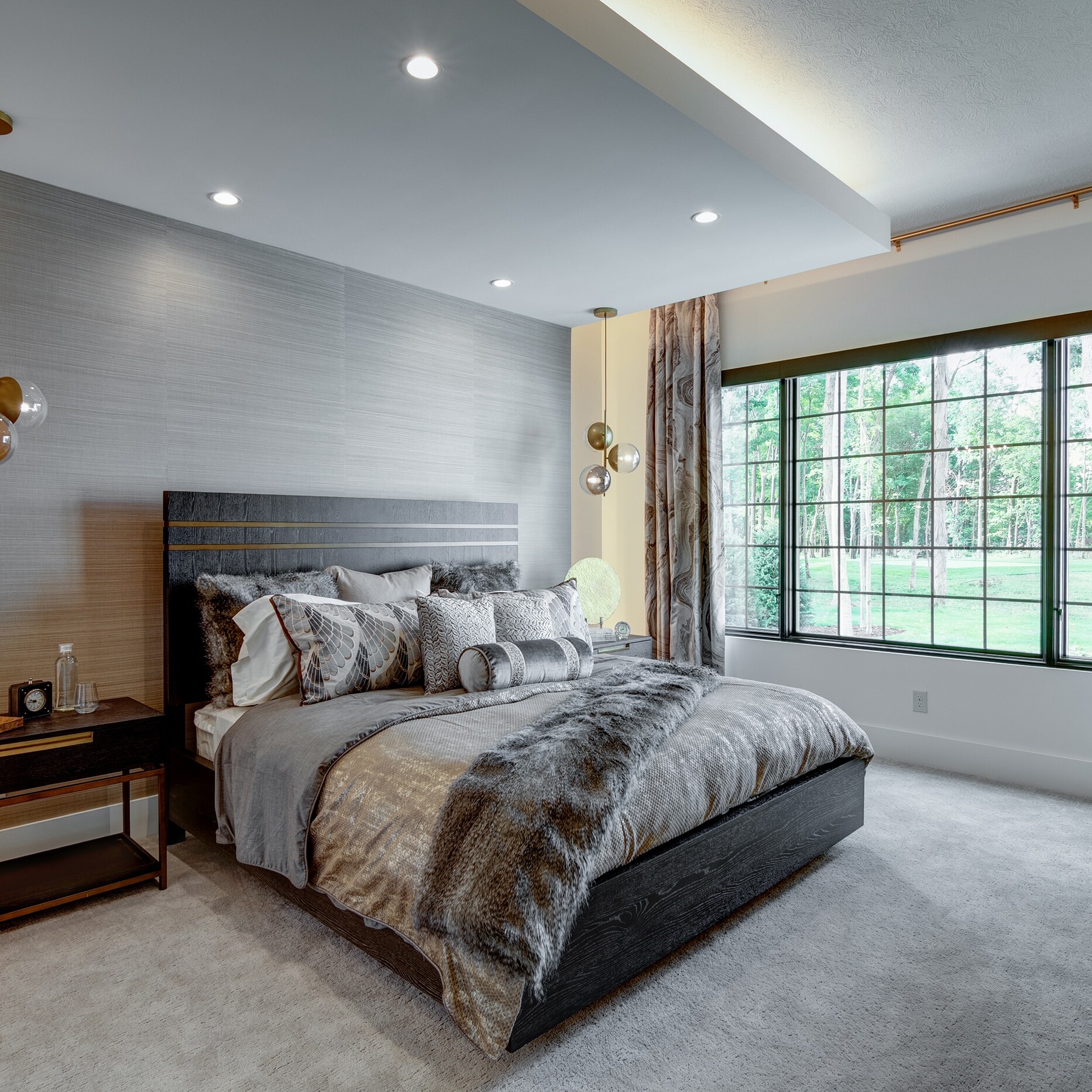 A bedroom with a large bed and a large window.