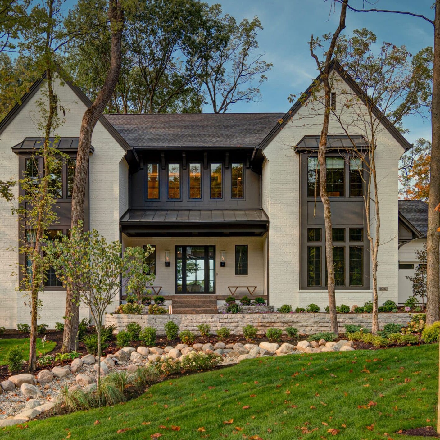 A spacious custom home in Westfield Indiana with a sprawling front yard adorned with beautiful trees.