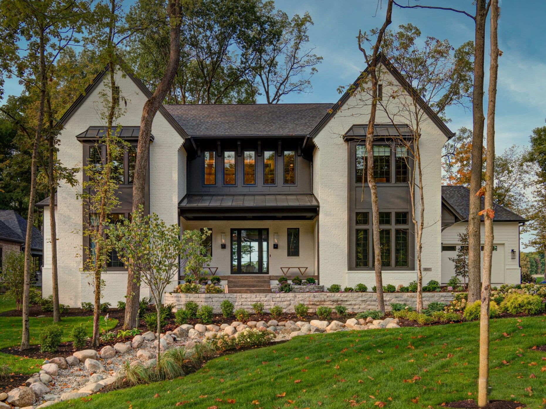 A spacious custom home in Westfield Indiana with a sprawling front yard adorned with beautiful trees.