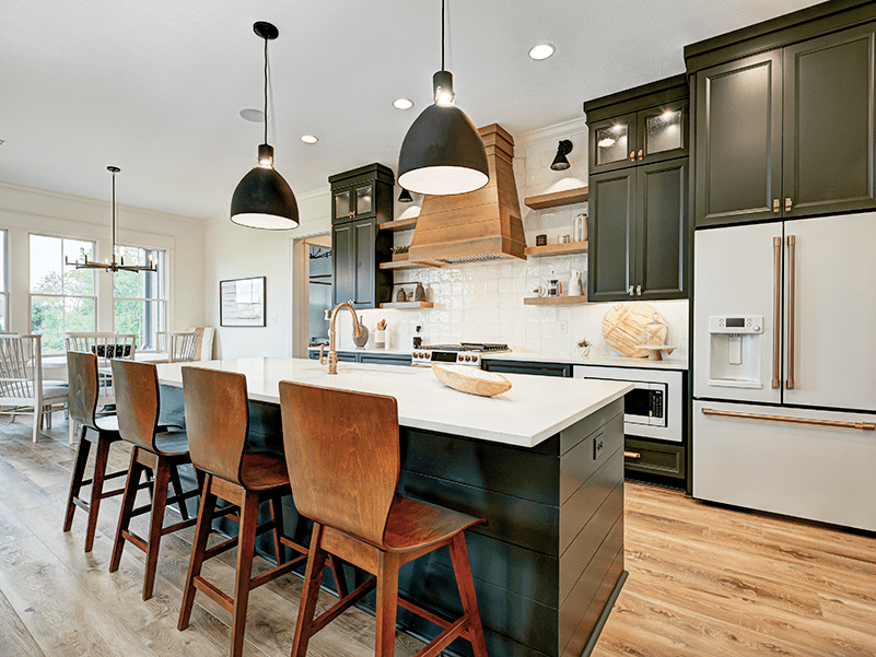 A kitchen with a center island and bar stools.